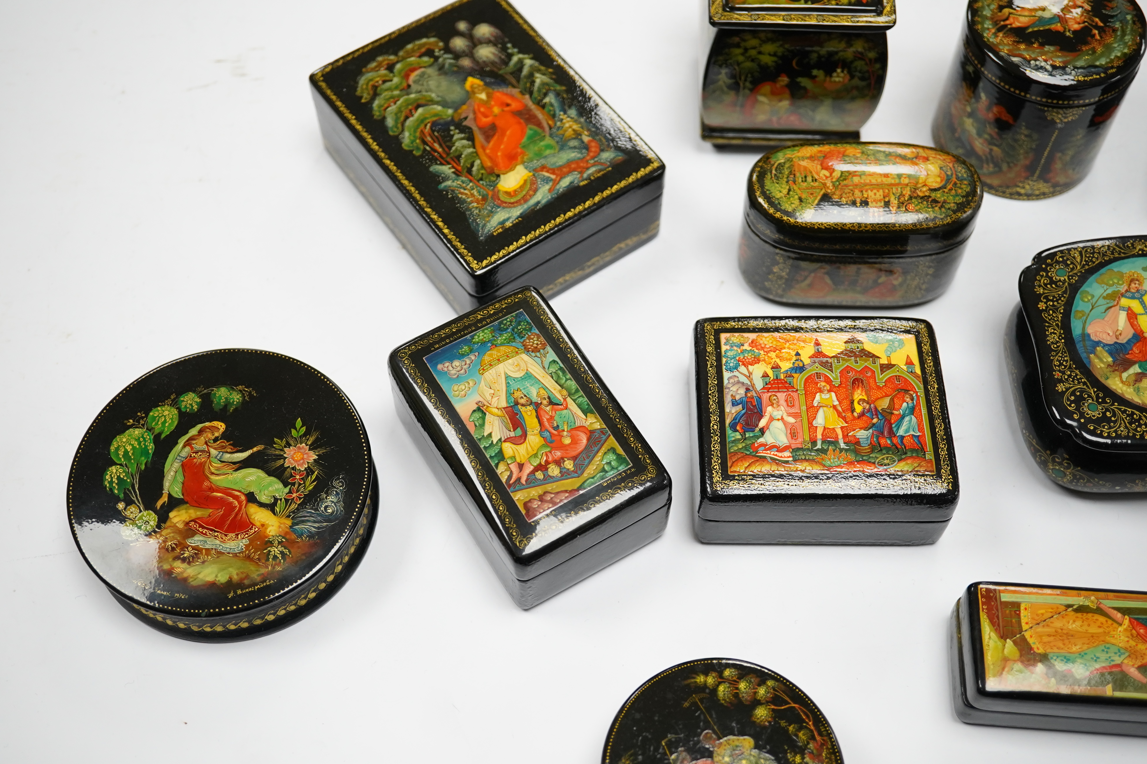 A quantity of Russian lacquer boxes decorated with figures and mythical scenes, largest 10cm in length. Condition - mostly good